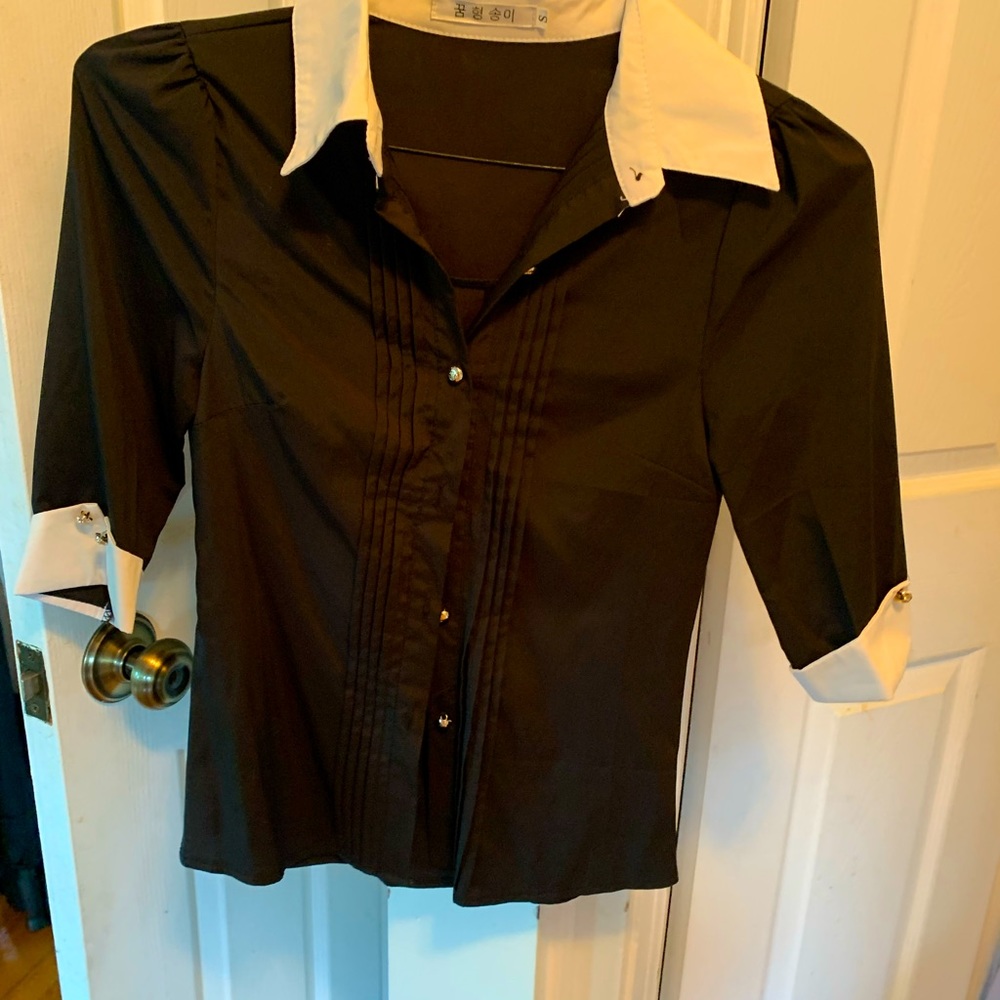 Shirt is black with white collar blouse.